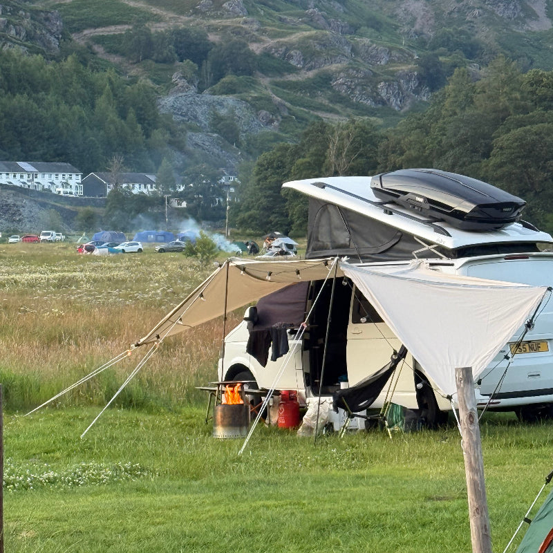 Glawning Glanopy set up on a grassy area with mountains in the background