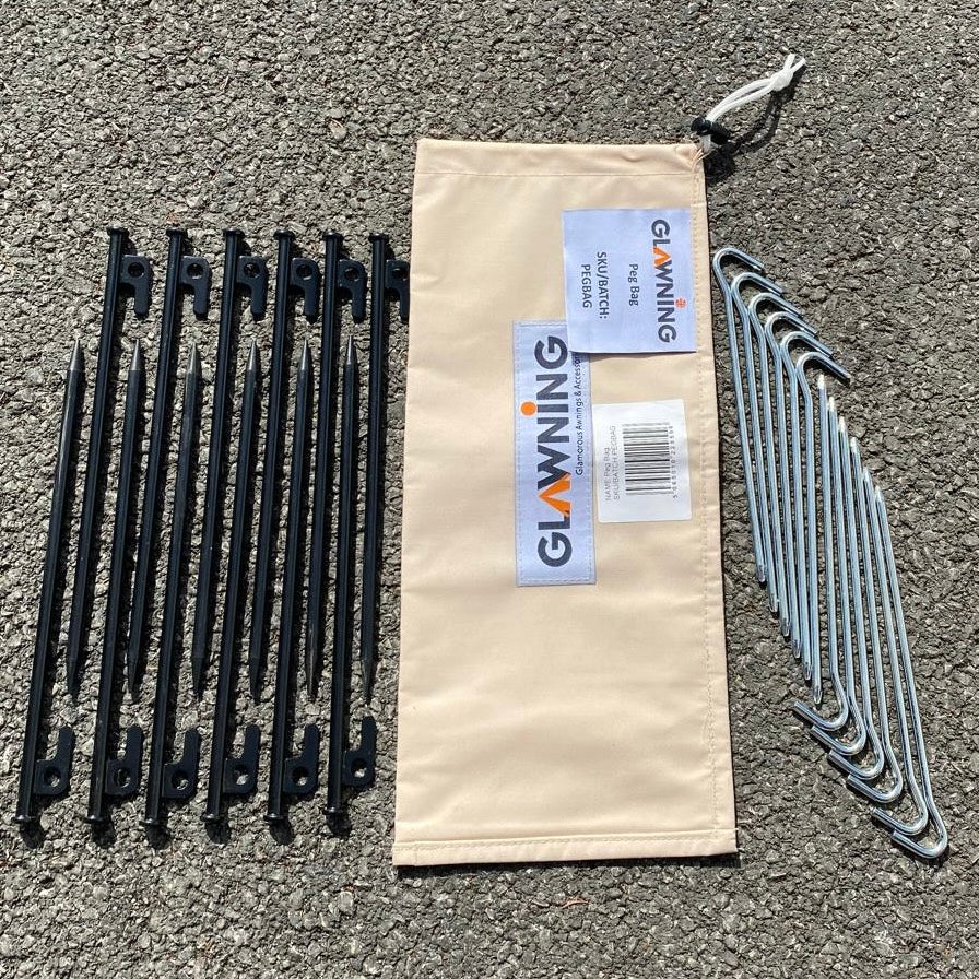 Set of black tent stakes, and silver tent pegs and a carrying bag with 'Glawning' branding on a concrete surface.